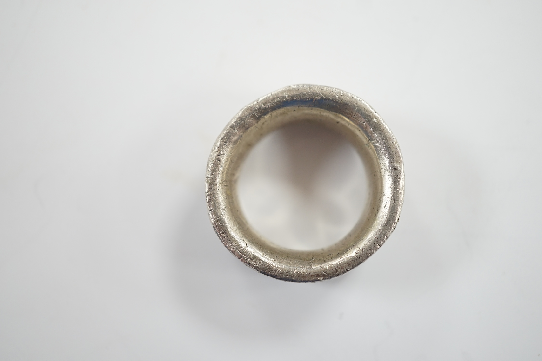 A carved heavy gauge white metal ring, thought to be of Viking origin?, size Q/R, 31.8 grams.